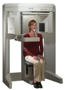 Patient sitting in a cone beam CT 3D imaging machine
