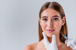 Woman getting filler into cheeck